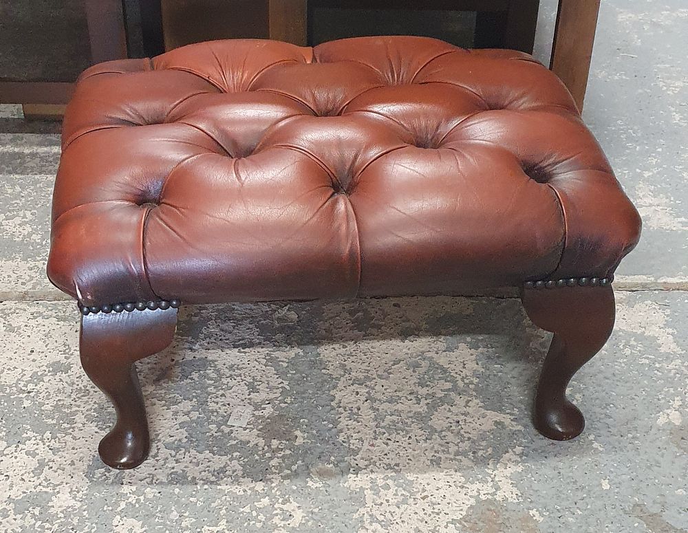 Lot 257: A mahogany and oxblood red leather Chesterfield footstool