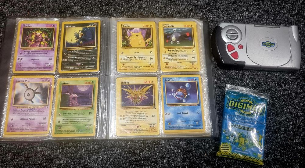 Lot 171: Folder of collectable Pokemon cards, Digimon trading cards and gaming console