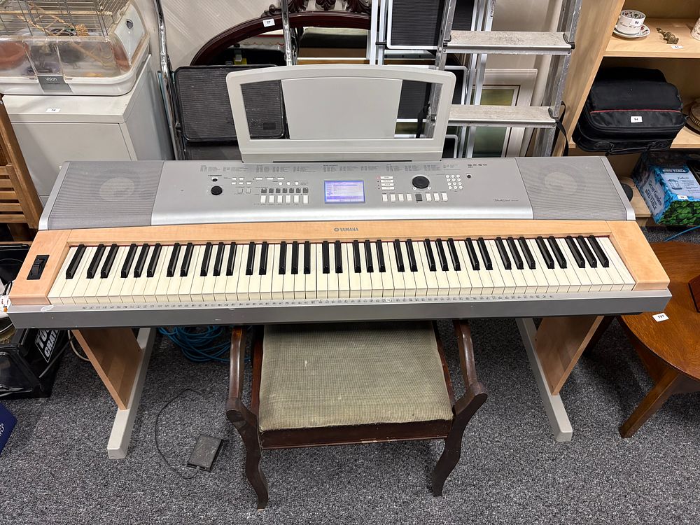 Lot 212: Yamaha Portable Grand Piano.