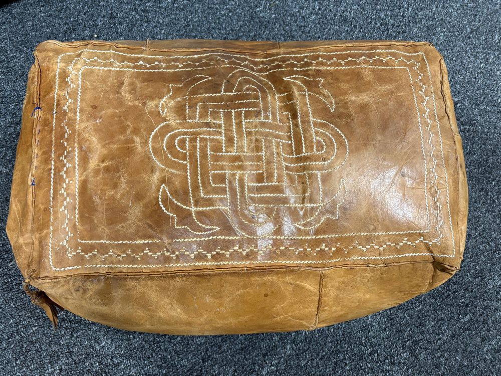 Lot 41: This is a handmade Moroccan leather pouf with a geometric embroidery desigen.