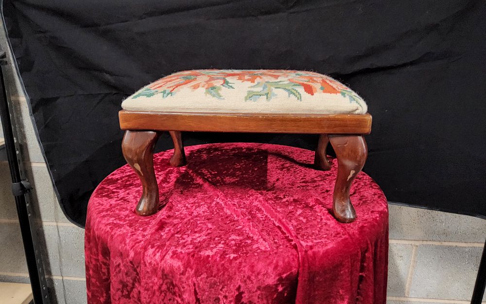 Lot 168: Tapestry covered wooden footstool.