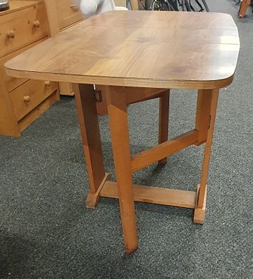 Small drop leaf table . Great for saving space approx 35 length 24" wide 29 " high . When folded 