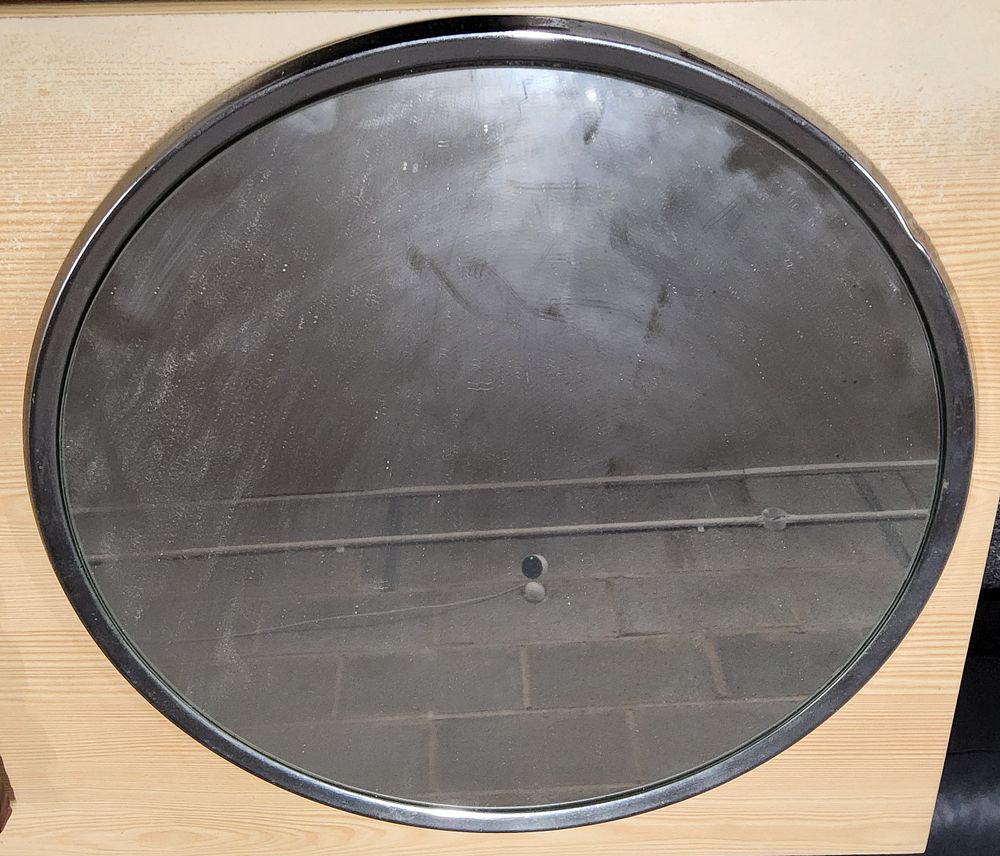 Lot 205: Round mirror on metal base.