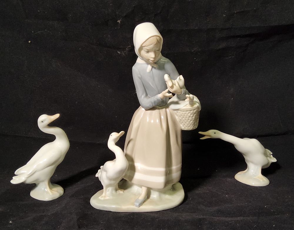 Lot 235: Lladro "Shepherdess with Ducklings" 4568 plus two Duck/ Geese figures.