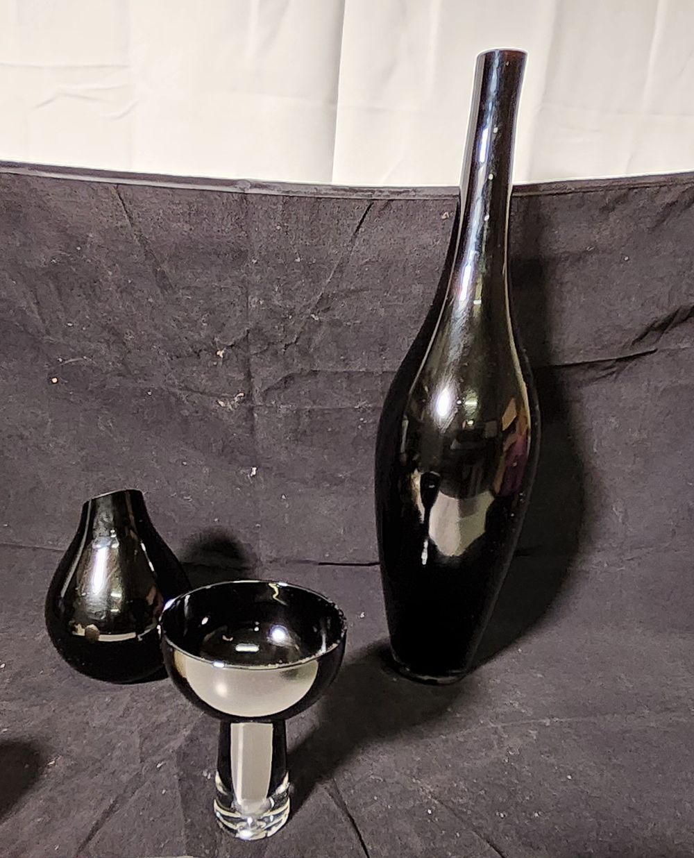 Lot 253: Black glass vases and candle holder.