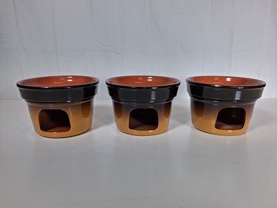 Terracota fondue pots . Can be used as fondue pots or oil burners . As pictured set of three .