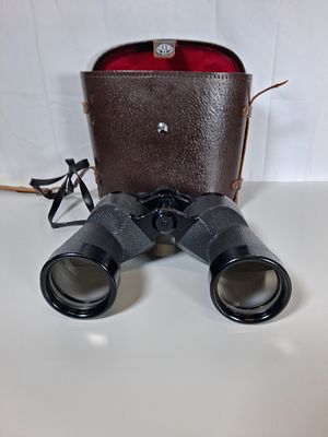 Pair of vintage cased binoculars . As pictured