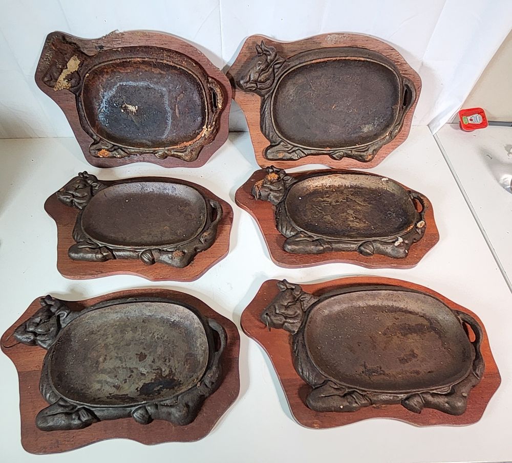 Lot 183: 6 x "Cow" Steak sizzler plates with wooden bases.