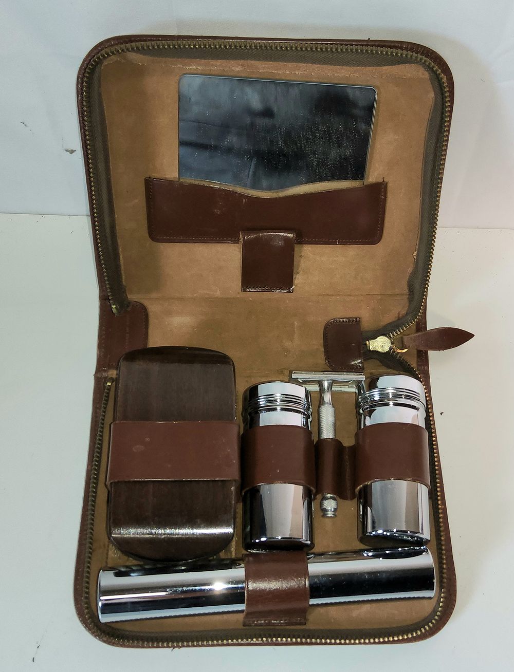 Lot 218: Vintage gentleman's travel grooming set in a brown zipped leather case. 