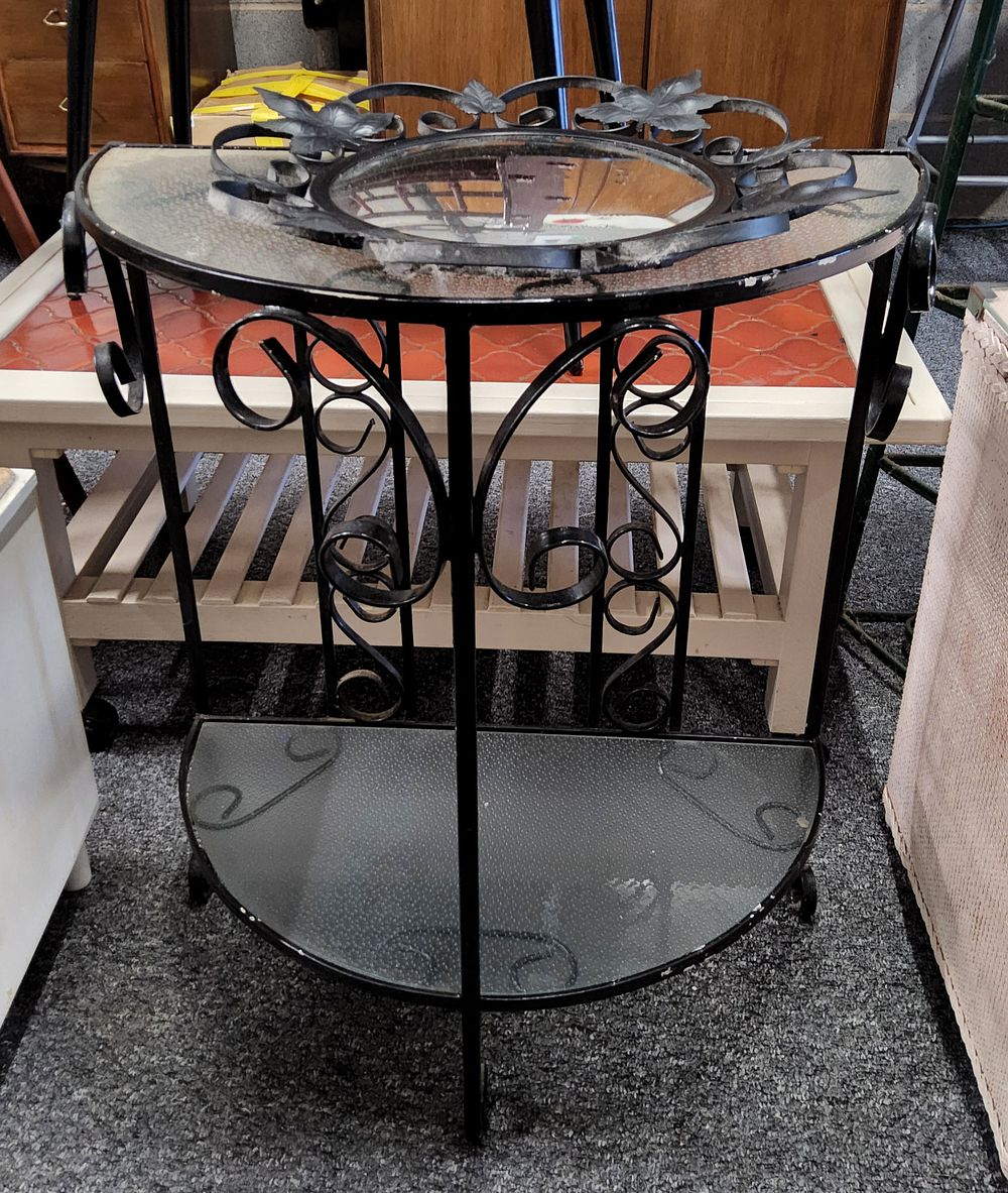 Lot 278: Wrought iron console table with a Demi-lune glass top and a matching mirror. 
22" Diameter, 27" height.
16" Diameter Mirror.