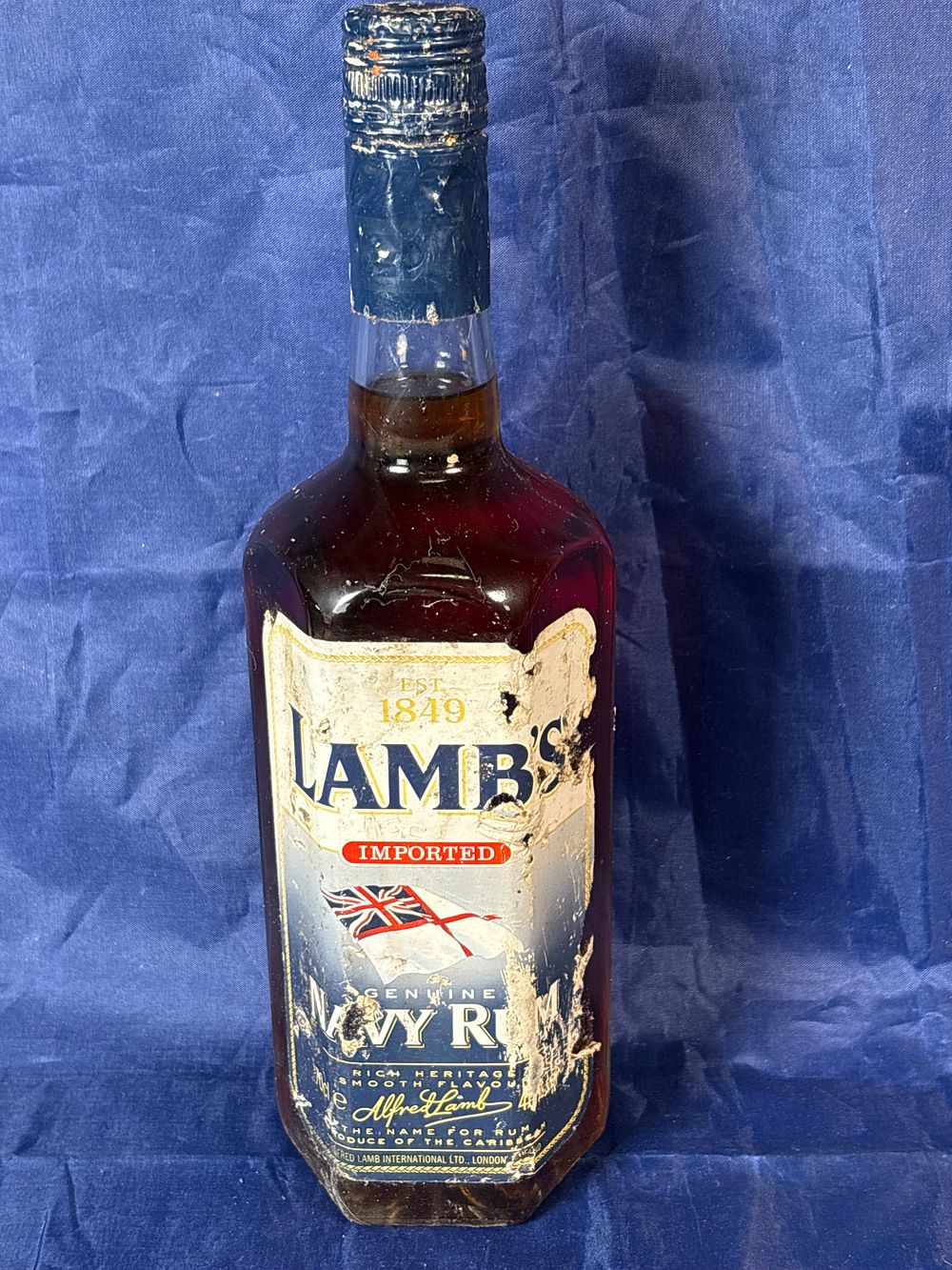 Lot 160: Sealed dirty bottle 70cl Lambs Navy Rum