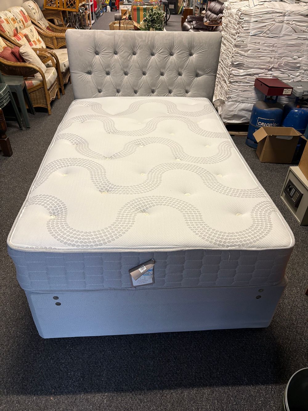 Lot 407: Virtually Brand New 4ft bed with headboard and mattress.