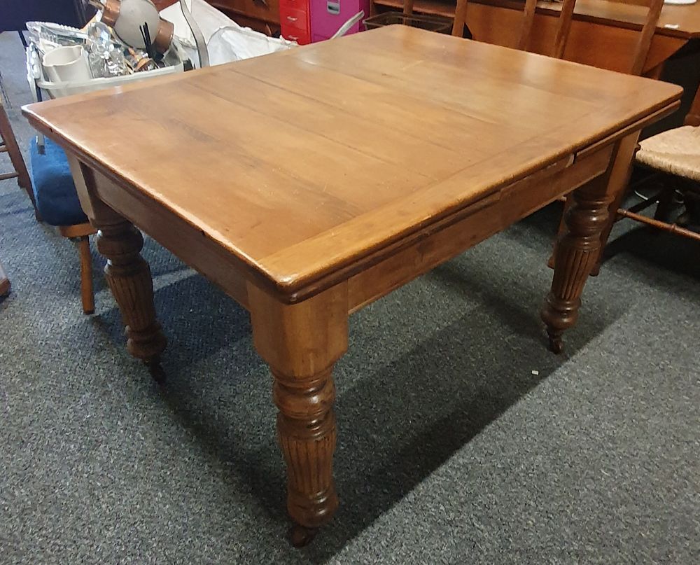 Lot 249: Antique solid oak farmhouse extending table on castors