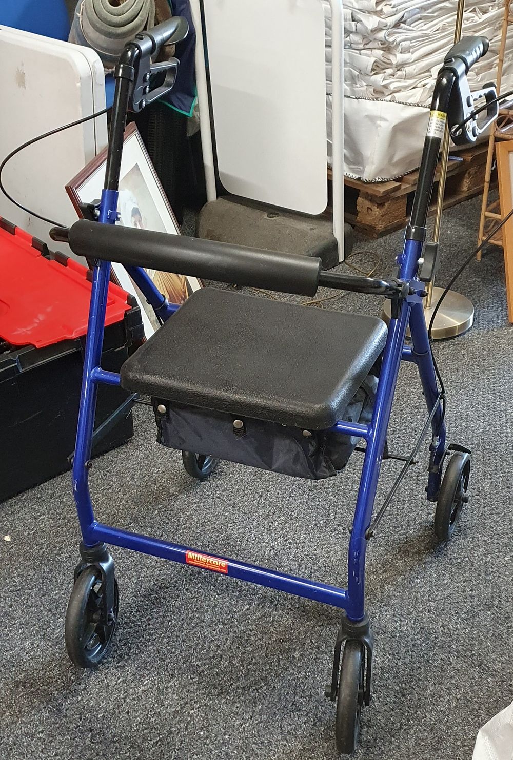 Lot 257: Four wheeled walker with brakes and seat with storage area