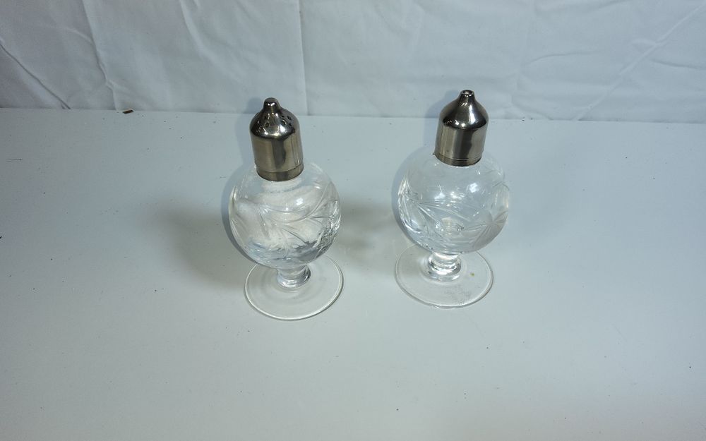 Lot 153: Vintage cut crystal salt and pepper shakers with silver plated tops