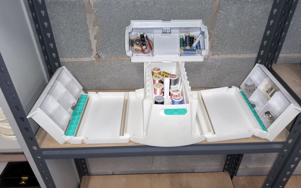 Lot 160: Portable sewing storage kit in white designed for organizing threads and accessories