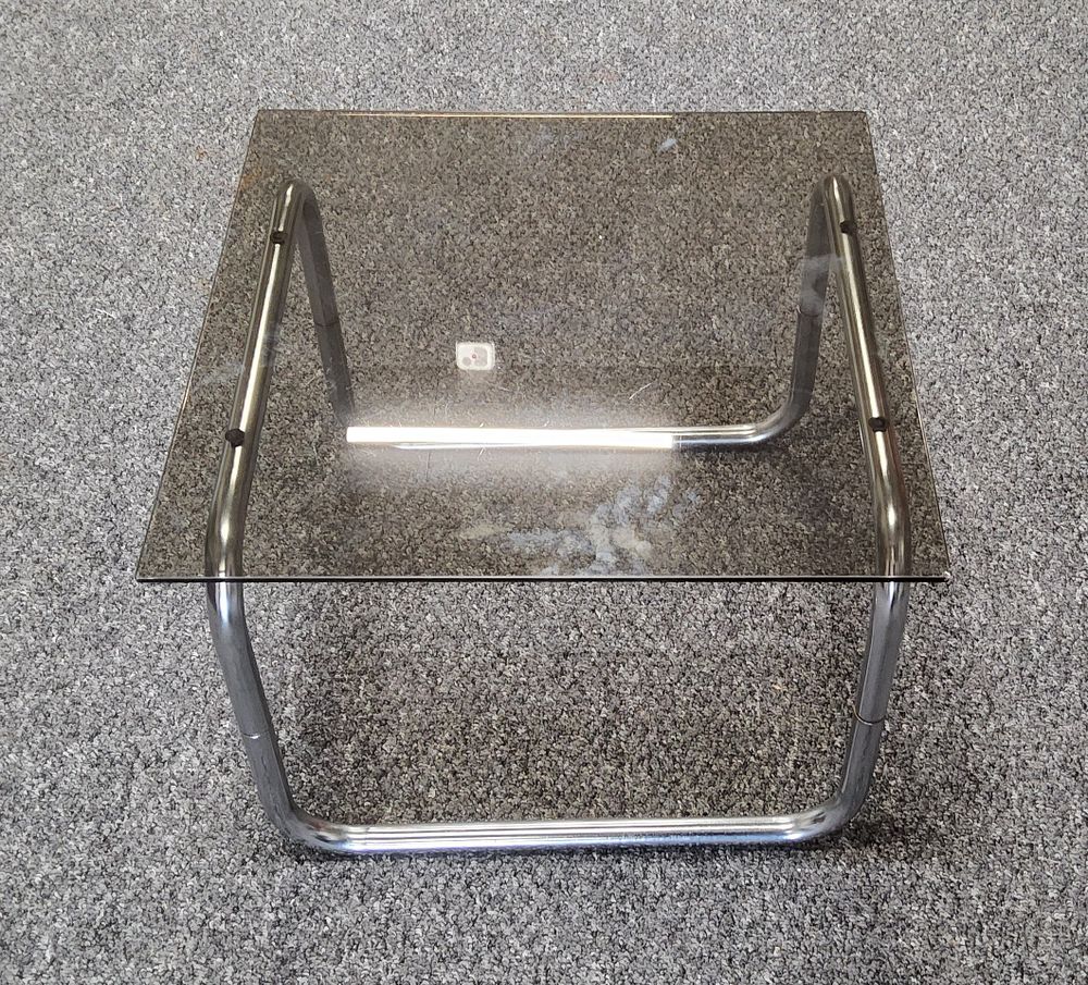 Lot 217: Glass topped tubular coffee table.