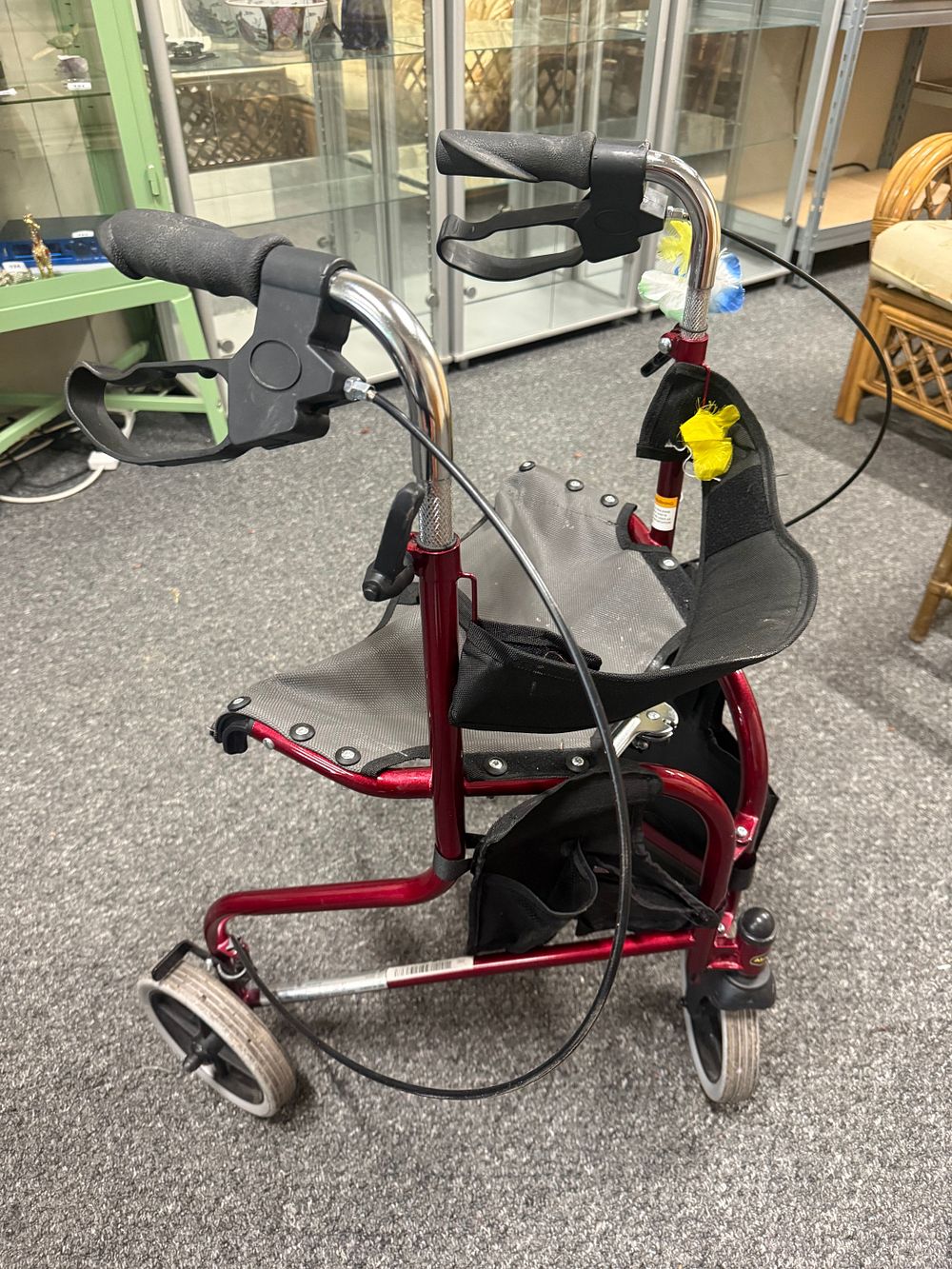Lot 166: A Lightweight Folding Three-Wheeled Metallic Red Rollator Walker