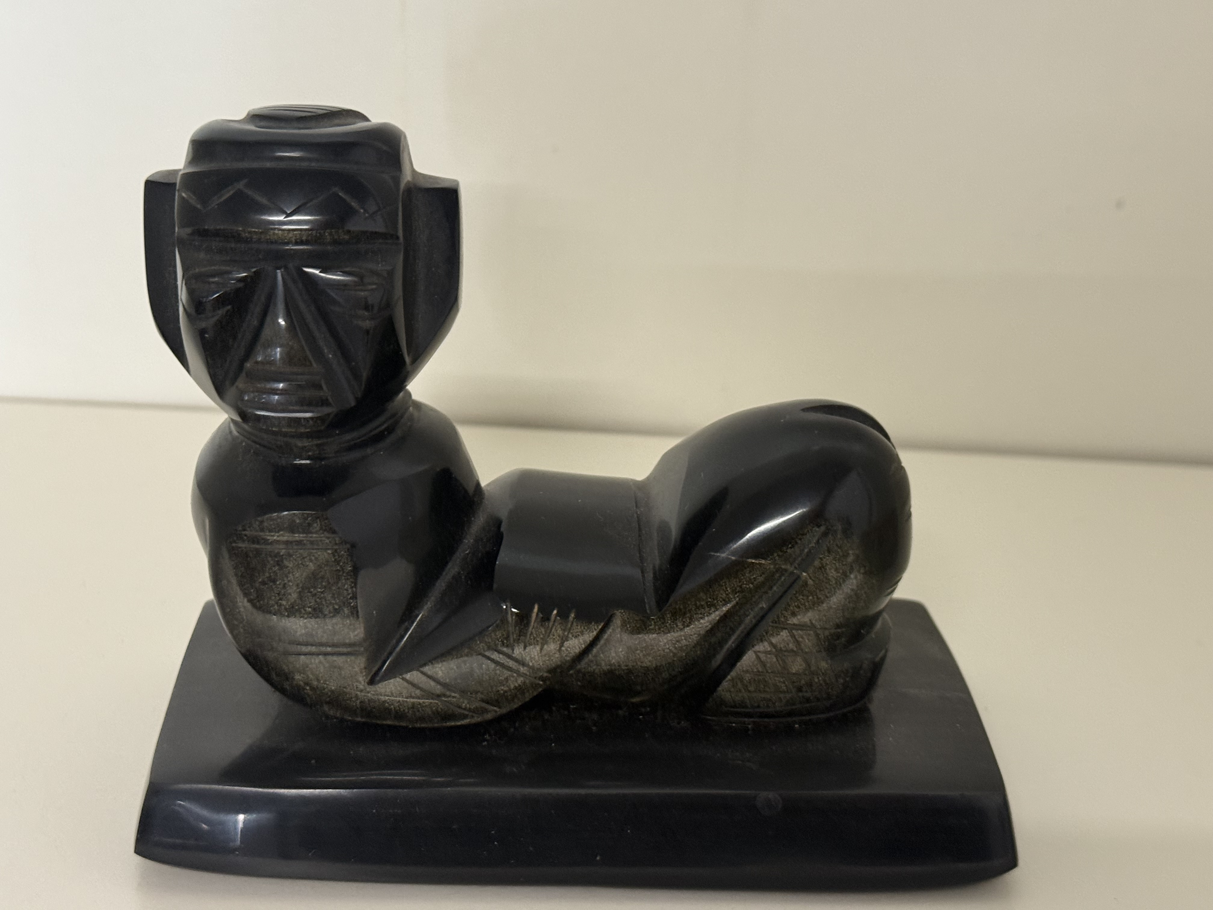A Carved Gold Sheen Obsidian Reclining Mesoamerican Chacmool Figure