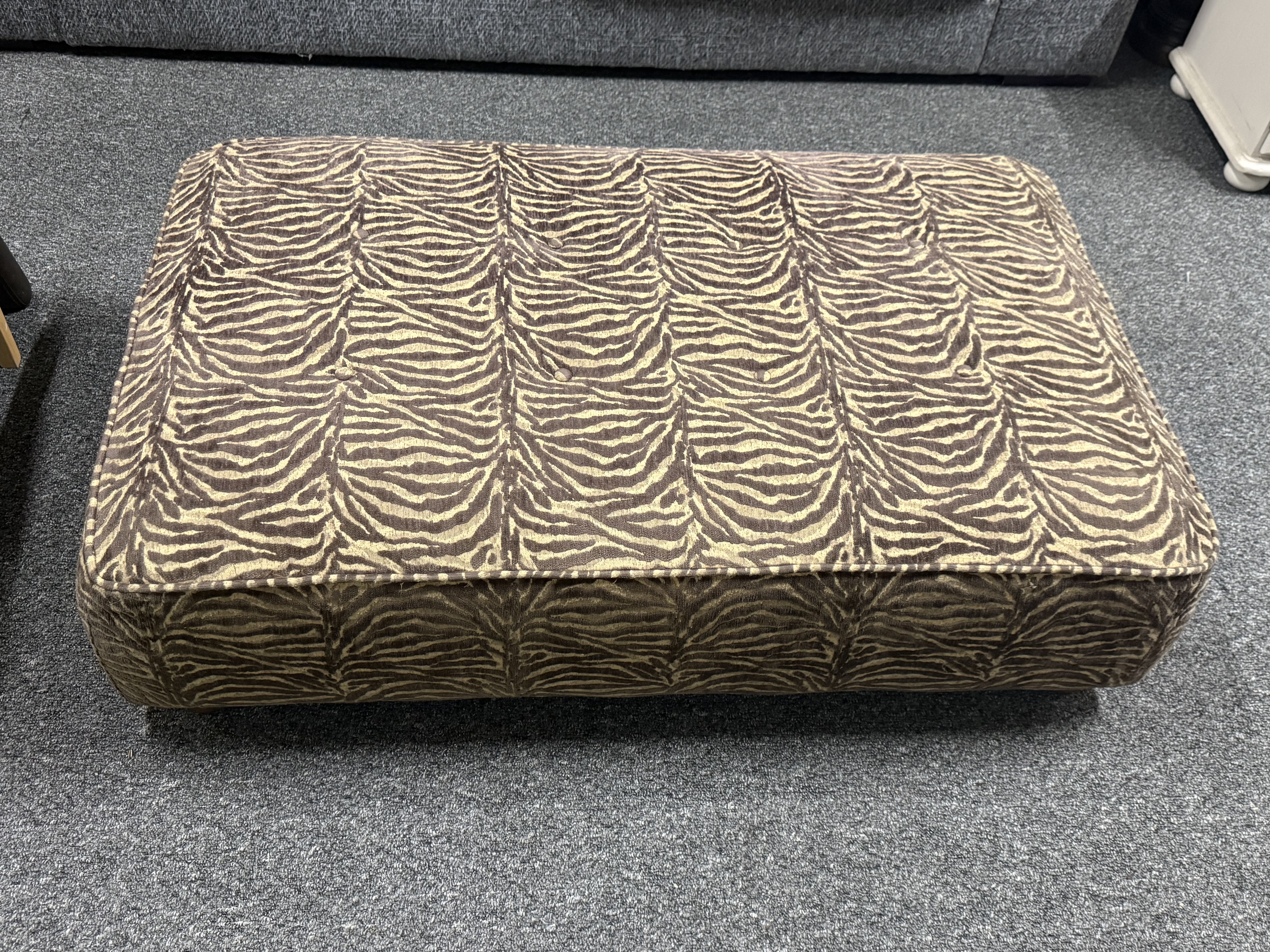 A large contemporary zebra print button tufted upholstered rectangular Footstool