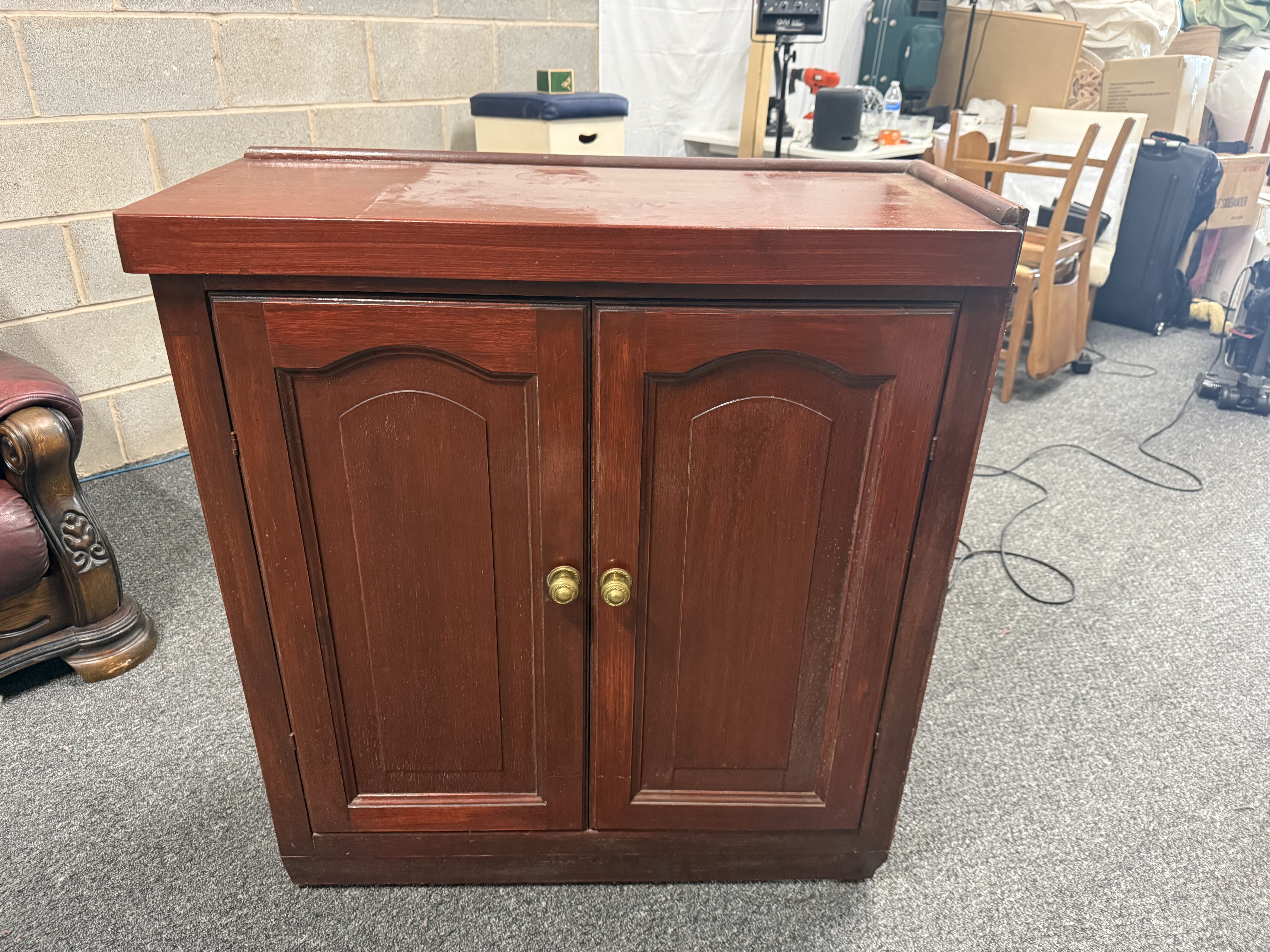 Mid-20th century mahogany finish two-door cupboard with gallery top