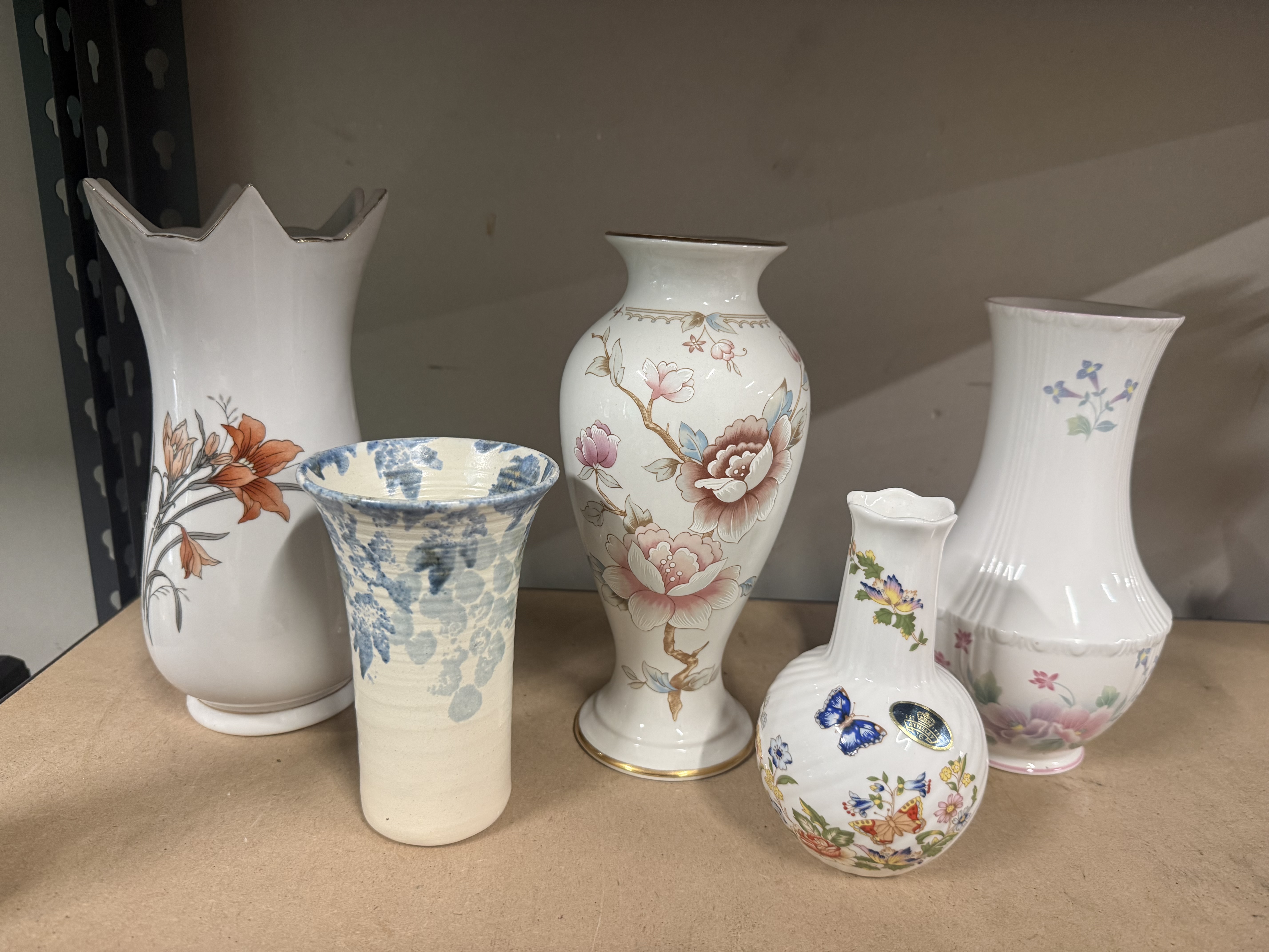 A collection of five assorted decorative floral ceramic vases