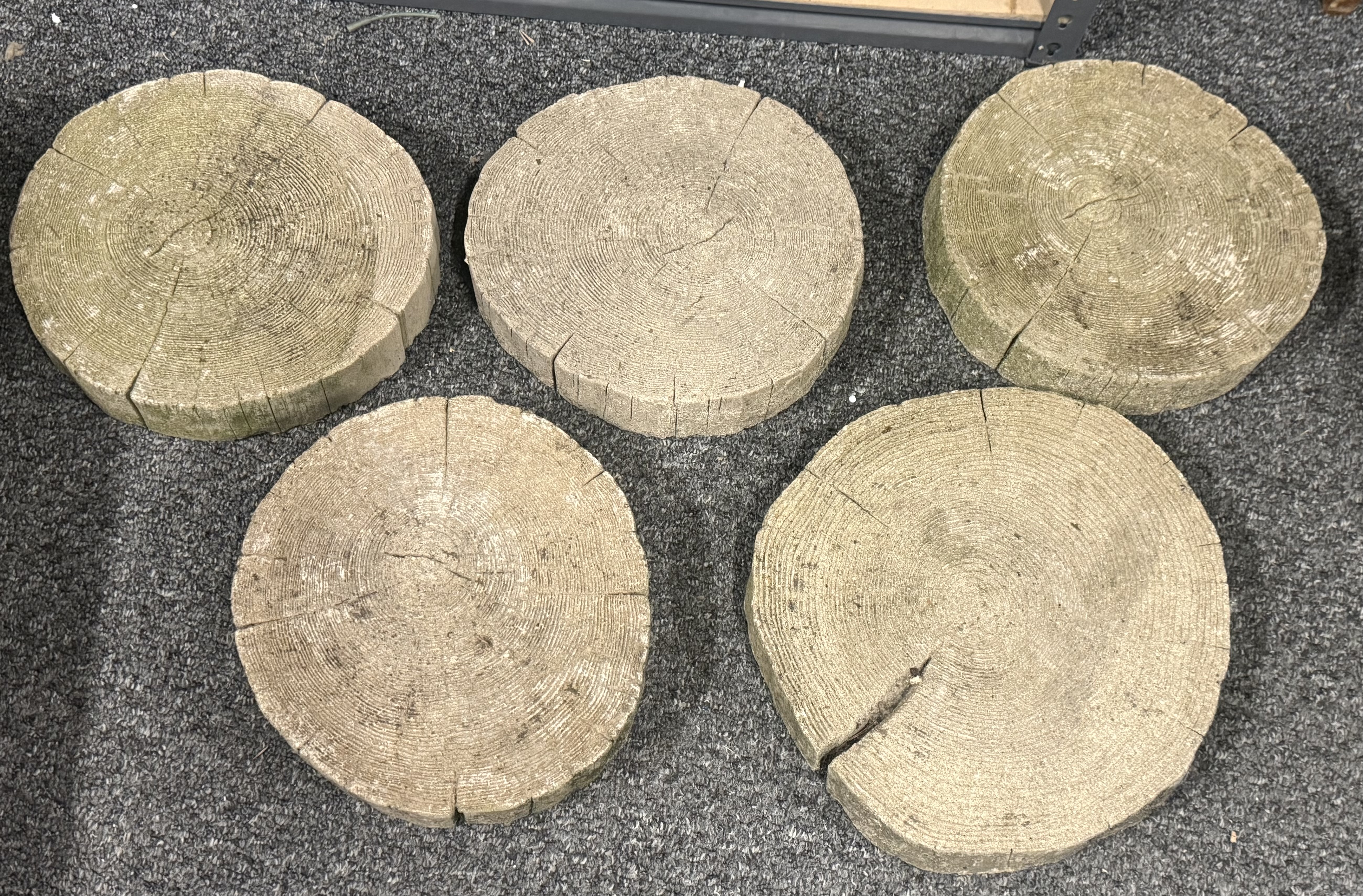 A set of five log effect cast stone stepping stones