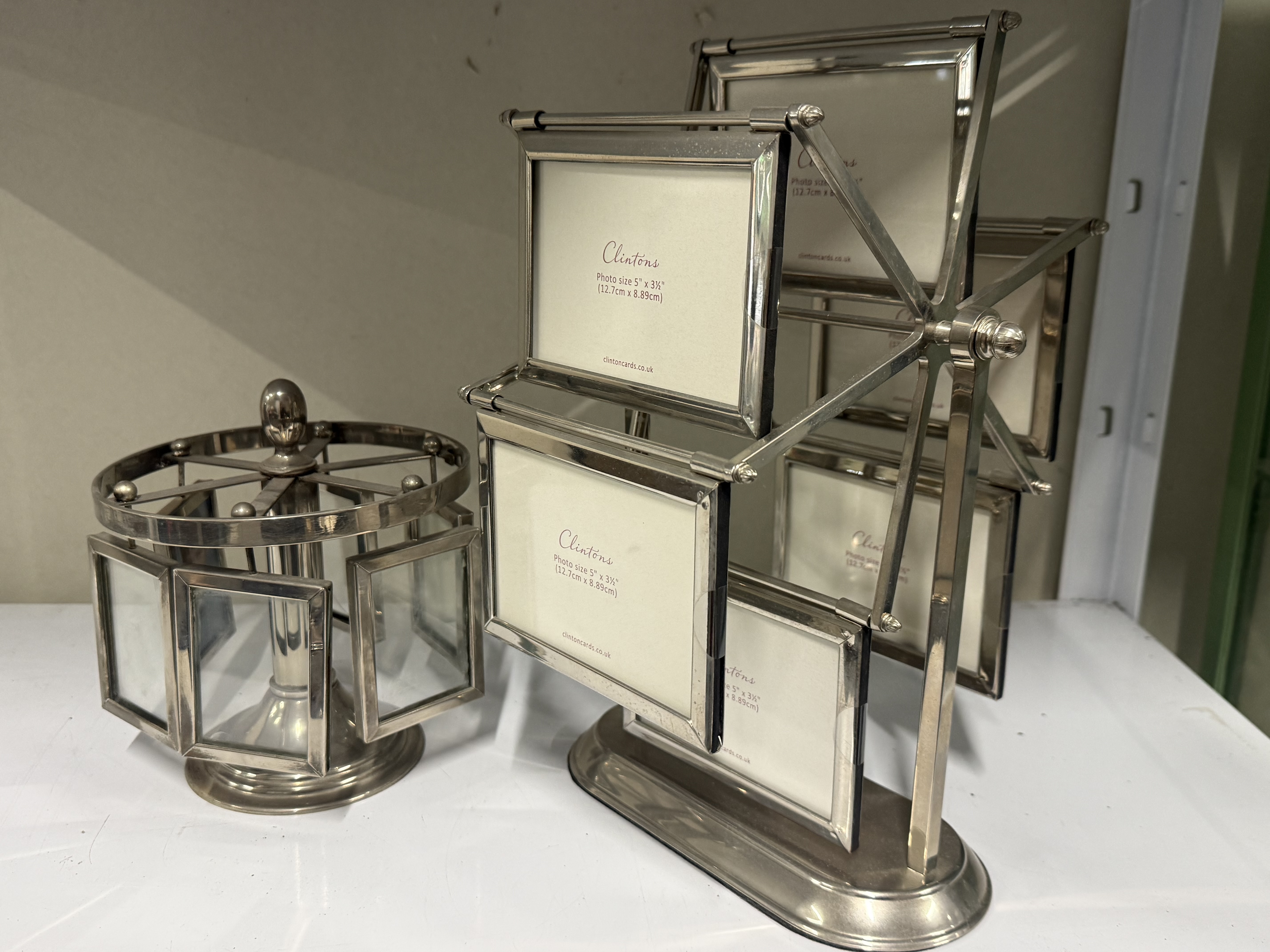 Two silver-plated novelty rotating photograph frames by Clintons