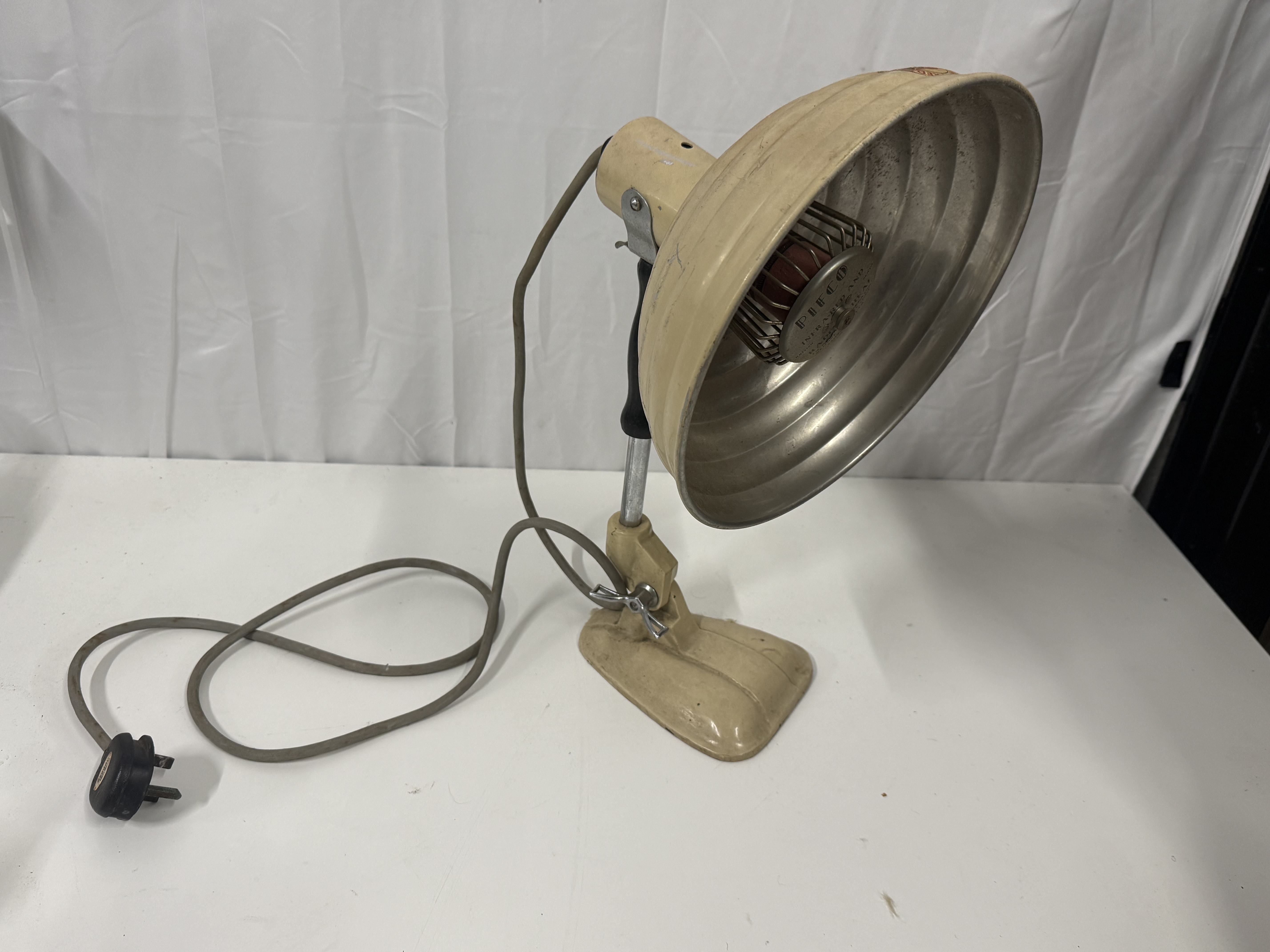 A mid-century Pifco industrial infra red radiant heat lamp