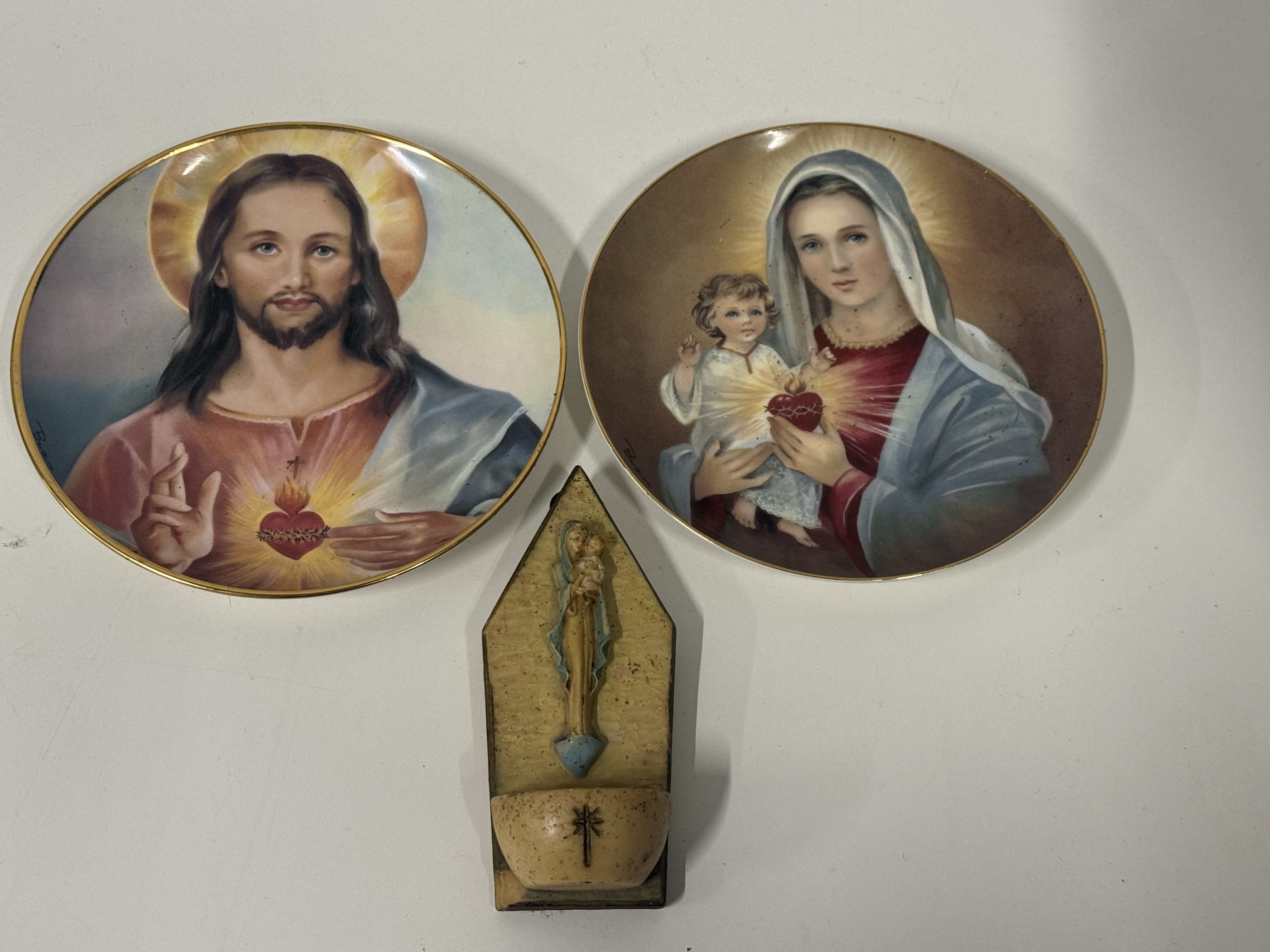 Three religious decorative items including two Royal Doulton collector plates