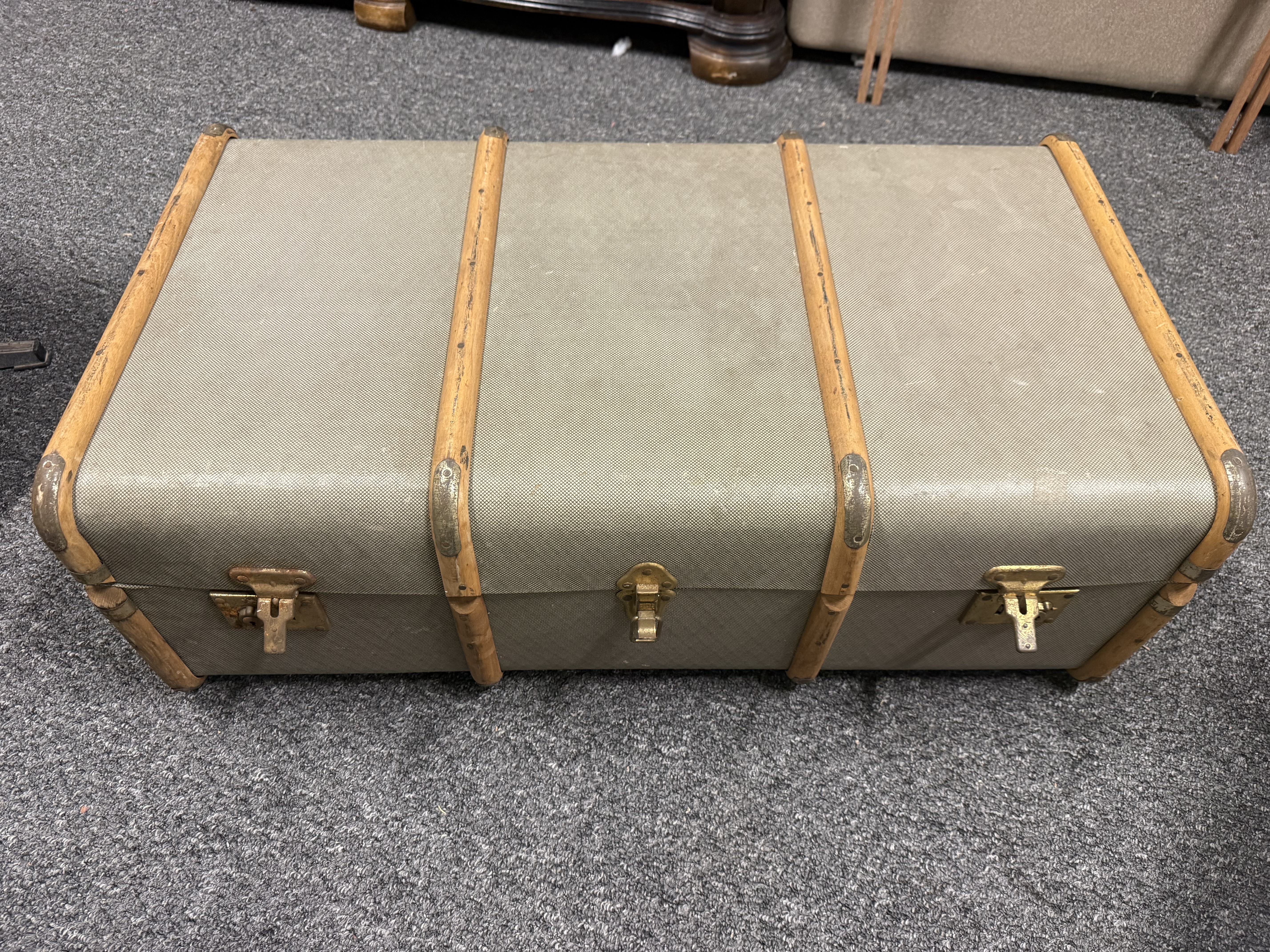 Mid-century wooden-slatted travel trunk with textured fabric look finish