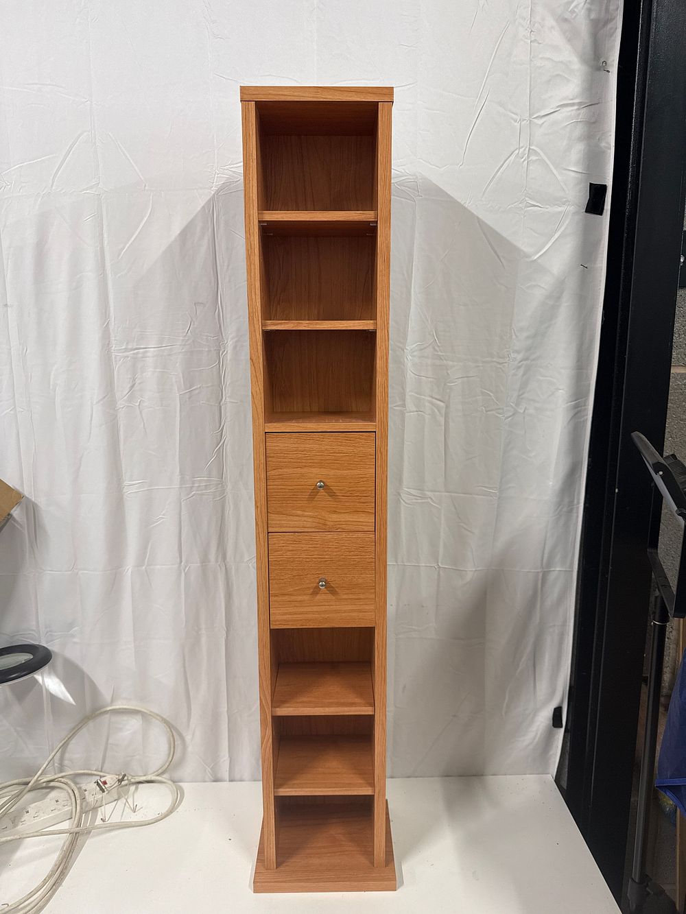 Lot 199: A contemporary light oak effect tall slim storage unit