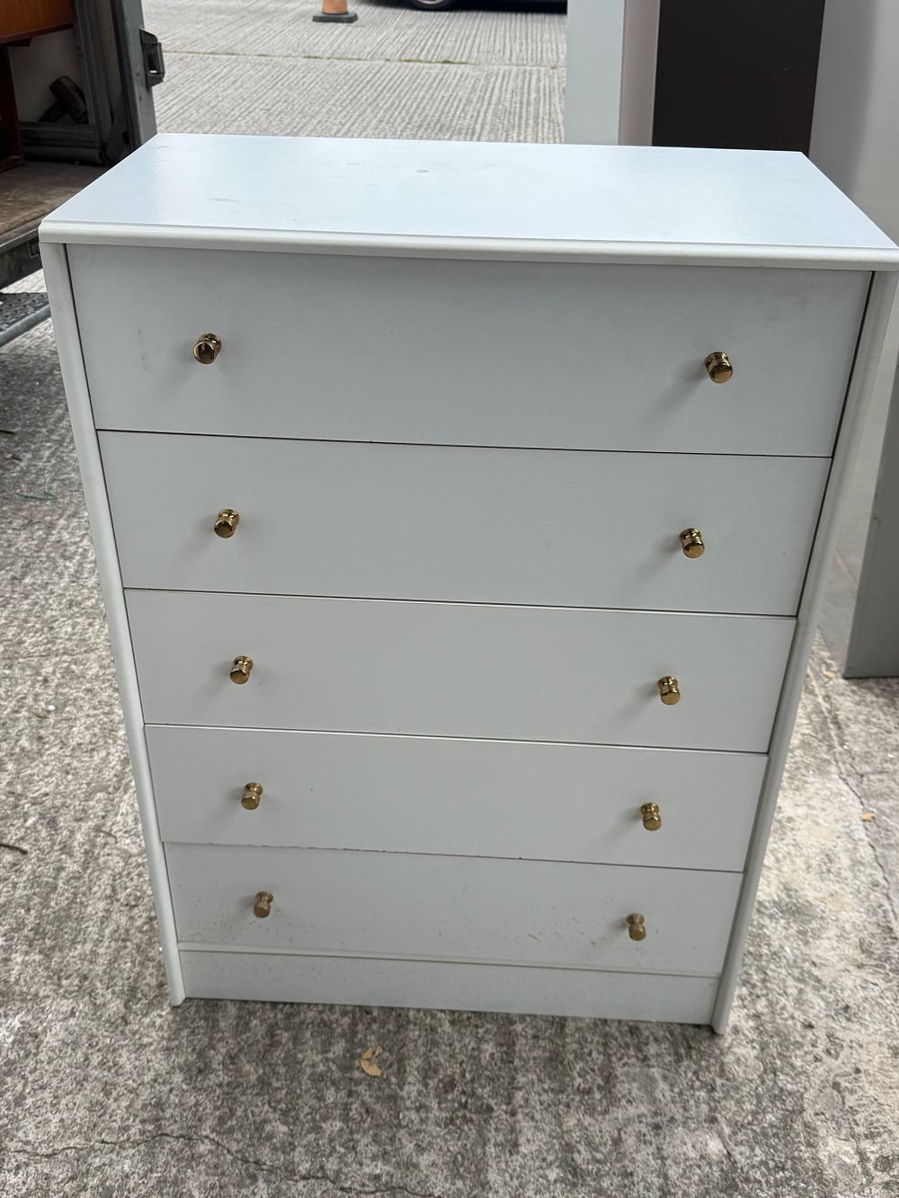 Lot 202: A Contemporary White Five Drawer Chest with Brass Knobs