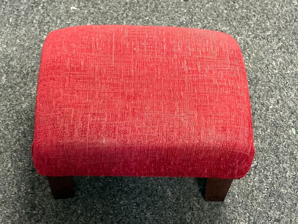 Lot 217: Contemporary upholstered footstool in red textured fabric with wooden legs