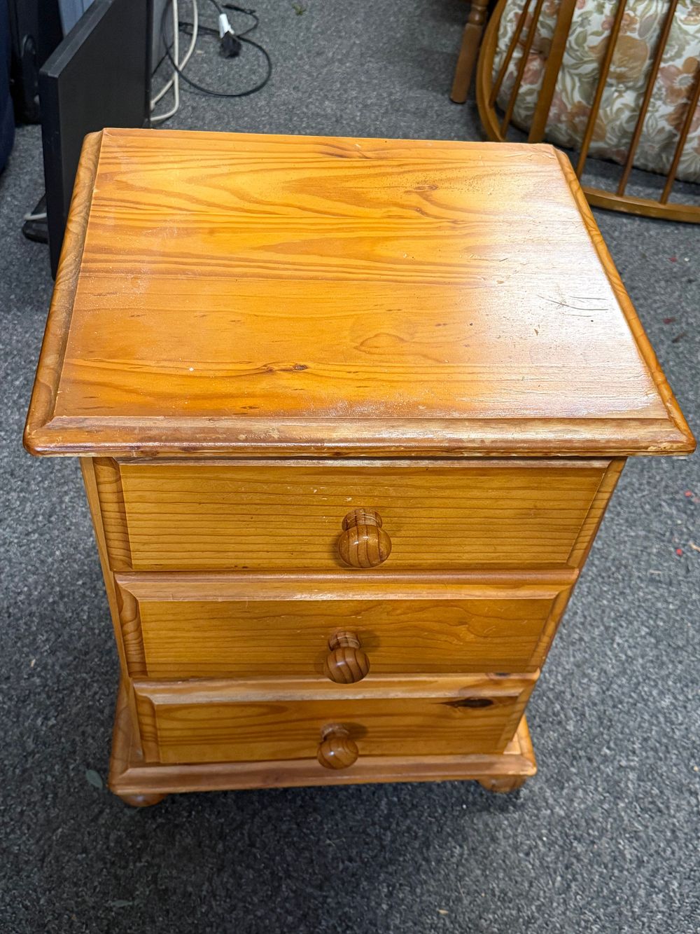 Lot 220: A modern solid pine three drawer bedside chest of drawers