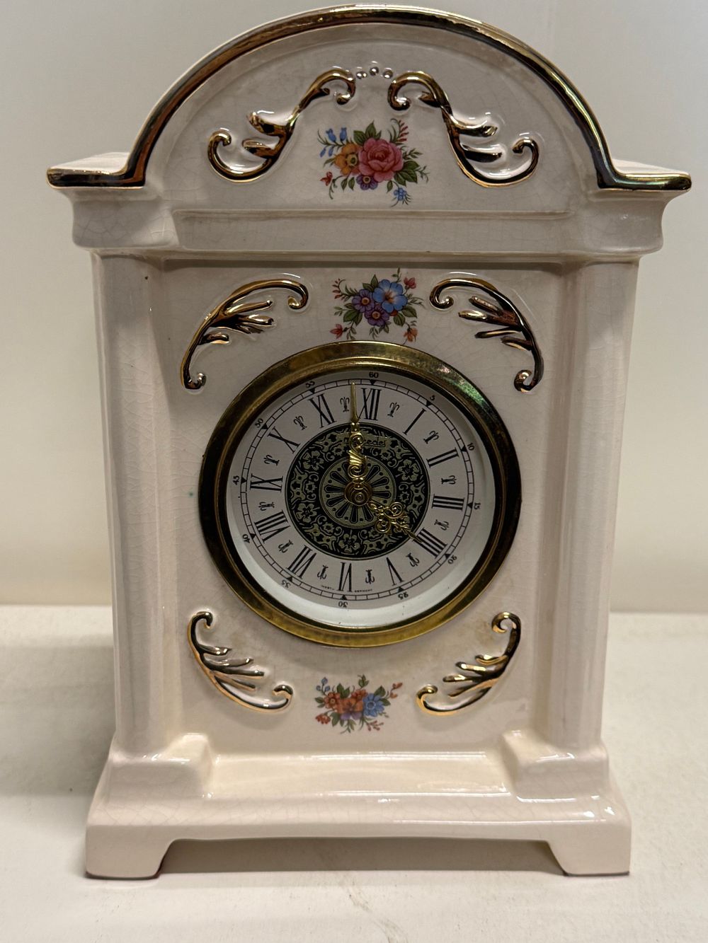 Lot 229: A Bencraft Stoke-on-Trent ceramic mantel clock with floral vignettes