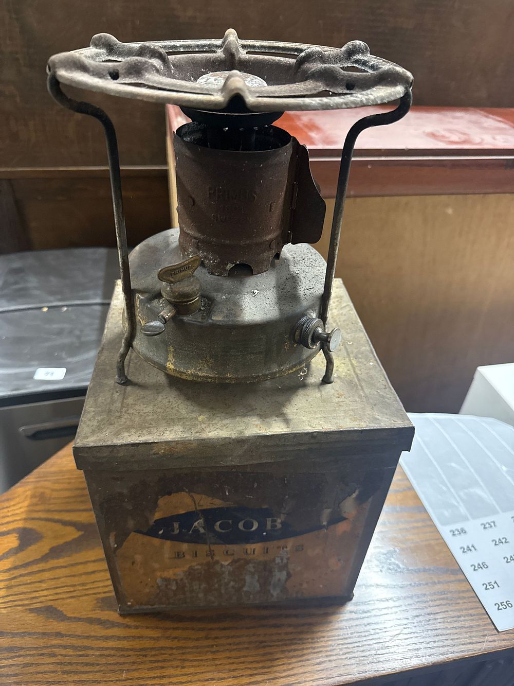 Lot 240: Vintage Primus pressure stove mounted in a Jacob's Biscuits tin