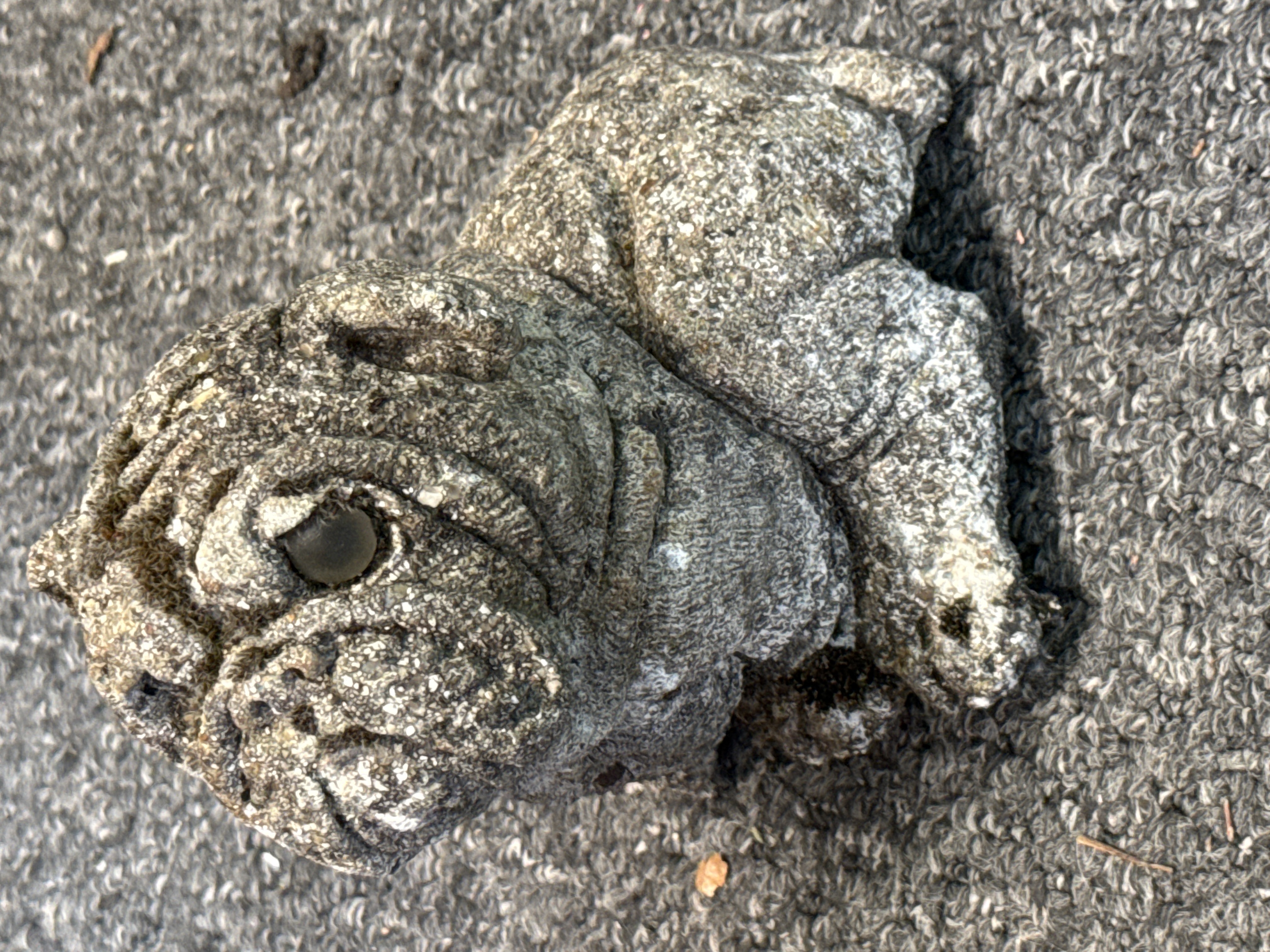 Cast stone garden figurine of a recumbent English Bulldog puppy