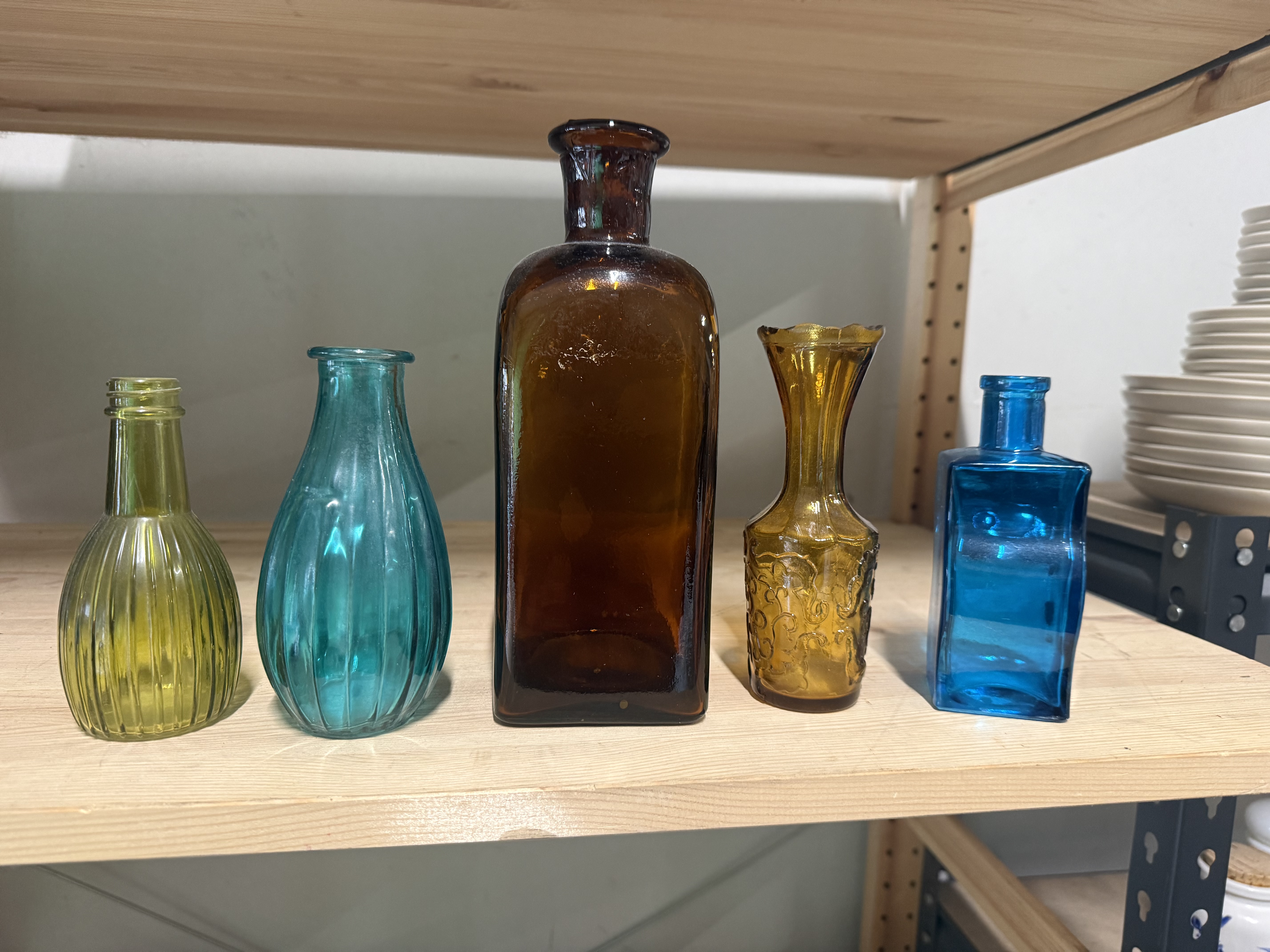 A collection of five decorative coloured vintage glass vessels