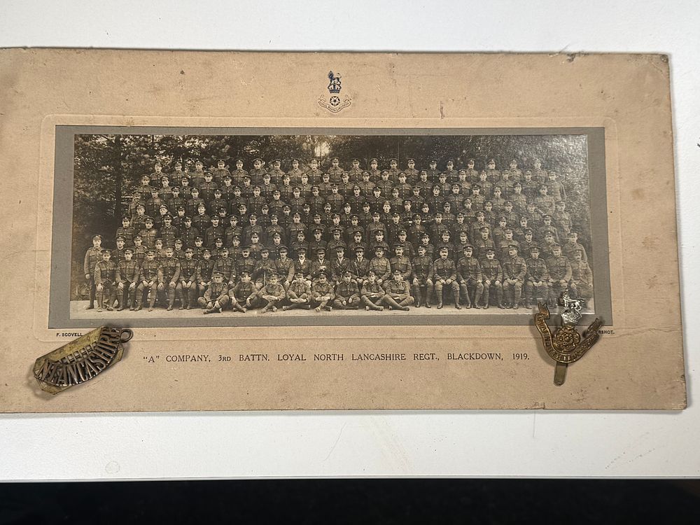 Lot 152: A 1919 Loyal North Lancashire Regiment group photograph and insignia
