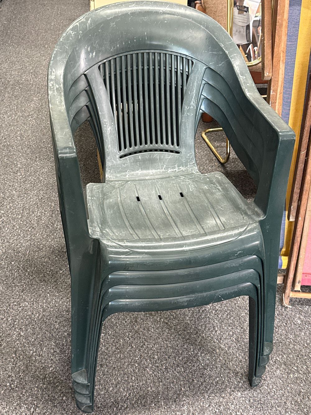 Lot 157: A group of four dark green stackable resin garden armchairs