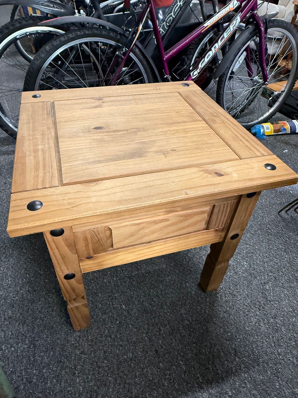 Lot 187: A contemporary Corona solid pine lamp table with metal studs