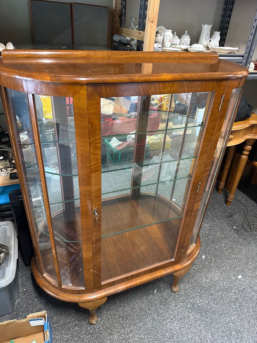 Lot 194: A mid-century walnut veneered bow-fronted display cabinet