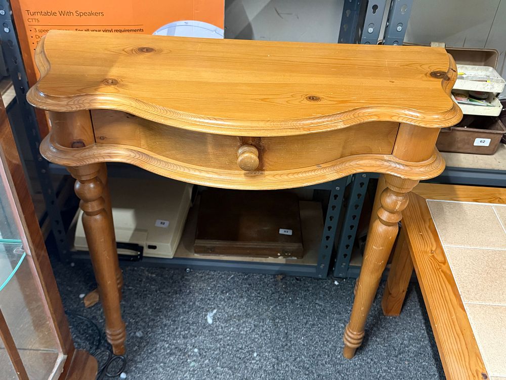 Lot 197: A traditional solid pine console table with scalloped front