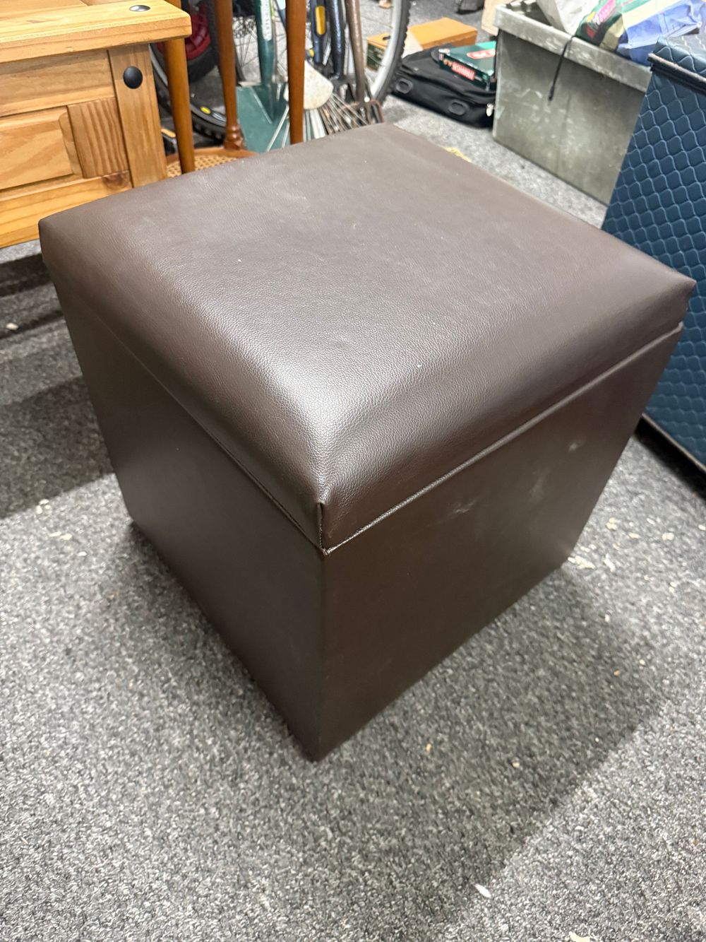 Lot 213: A contemporary brown faux-leather storage ottoman with removable lid