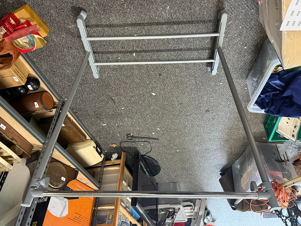 Lot 223: A height adjustable metal garment rack with four casters