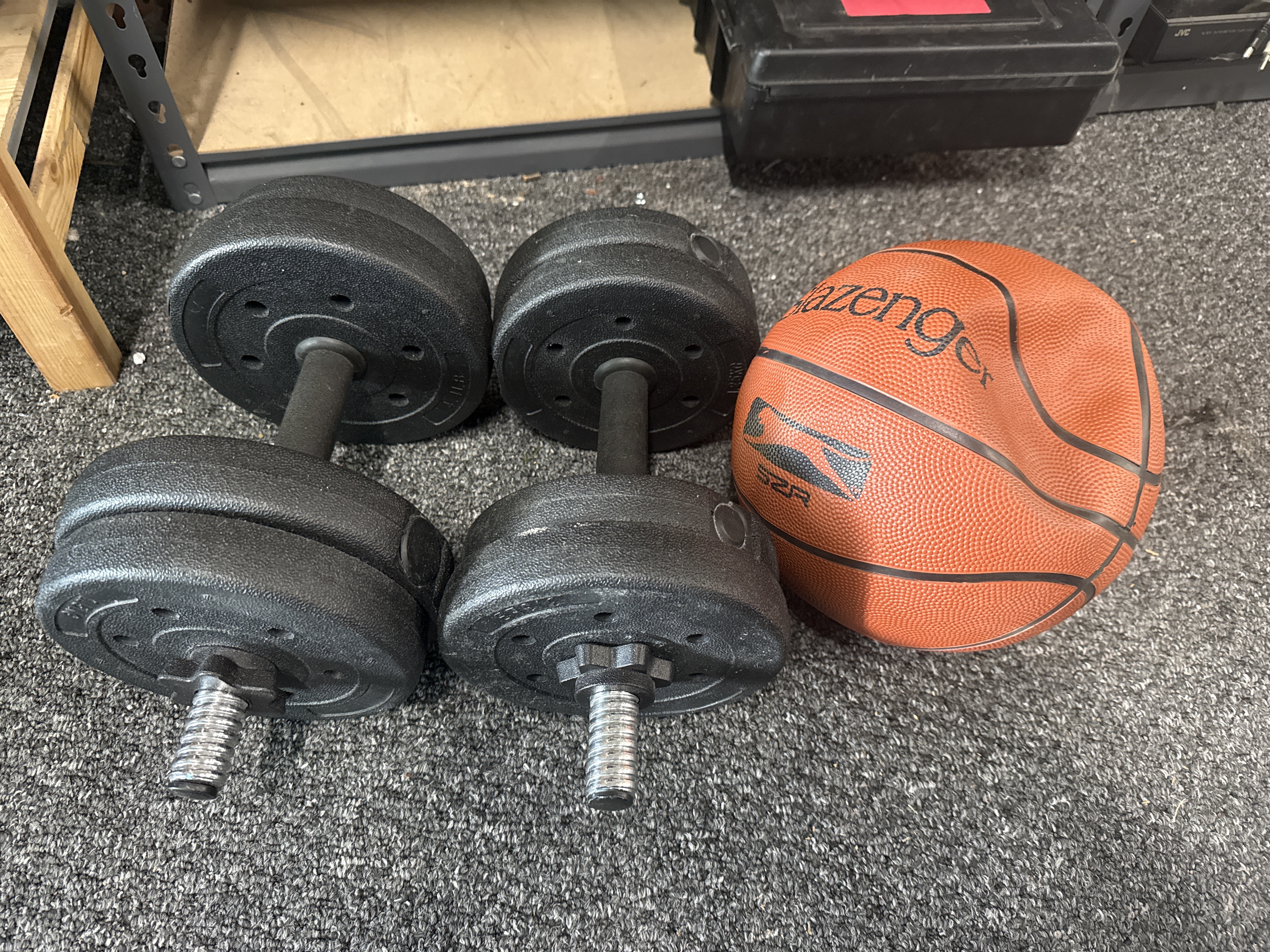 A pair of adjustable dumbbells and a Slazenger basketball