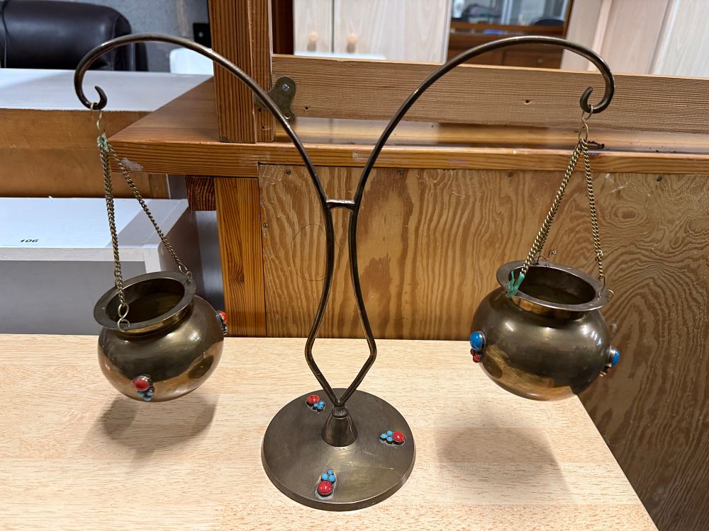 Lot 15: A twin-arm brass hanging pot stand with cabochon stone accents