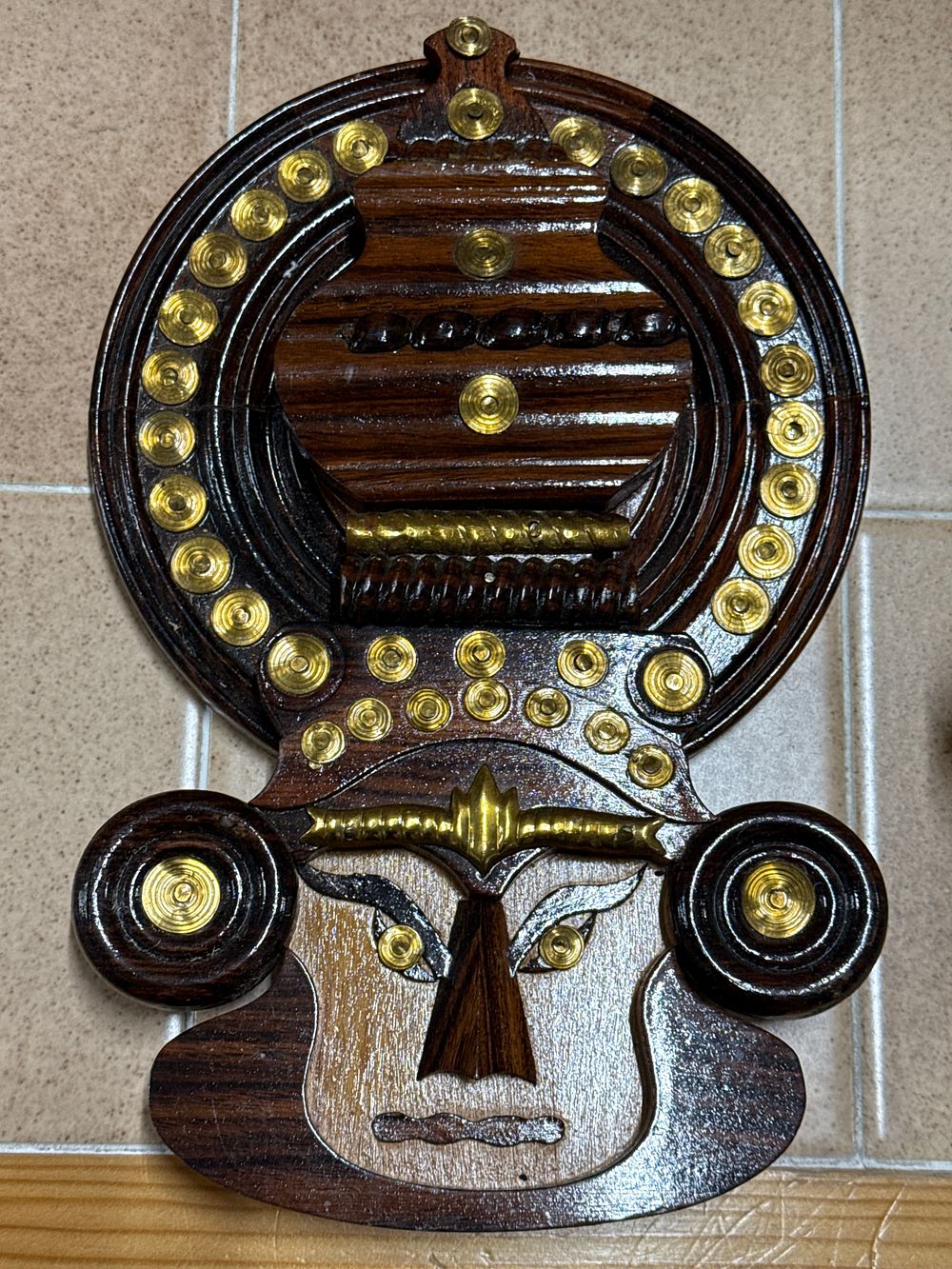 Lot 21: Hand-carved Indian wood and brass Kathakali mask wall hanging