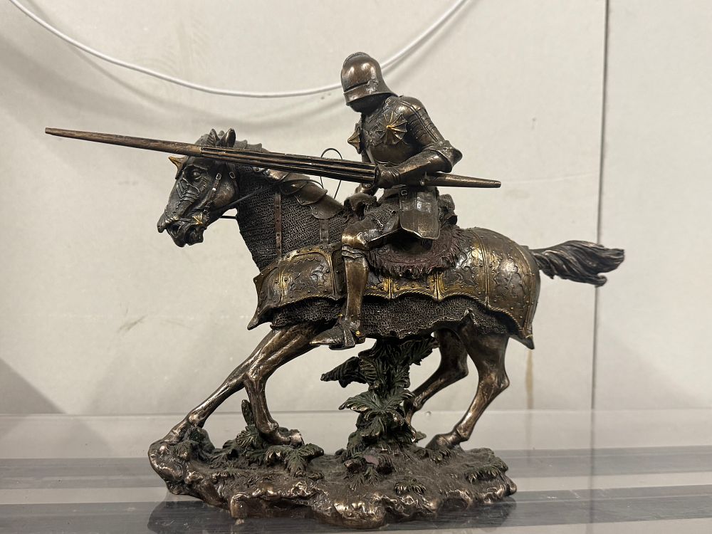 Lot 46: A cast resin figure of a mounted medieval charging knight